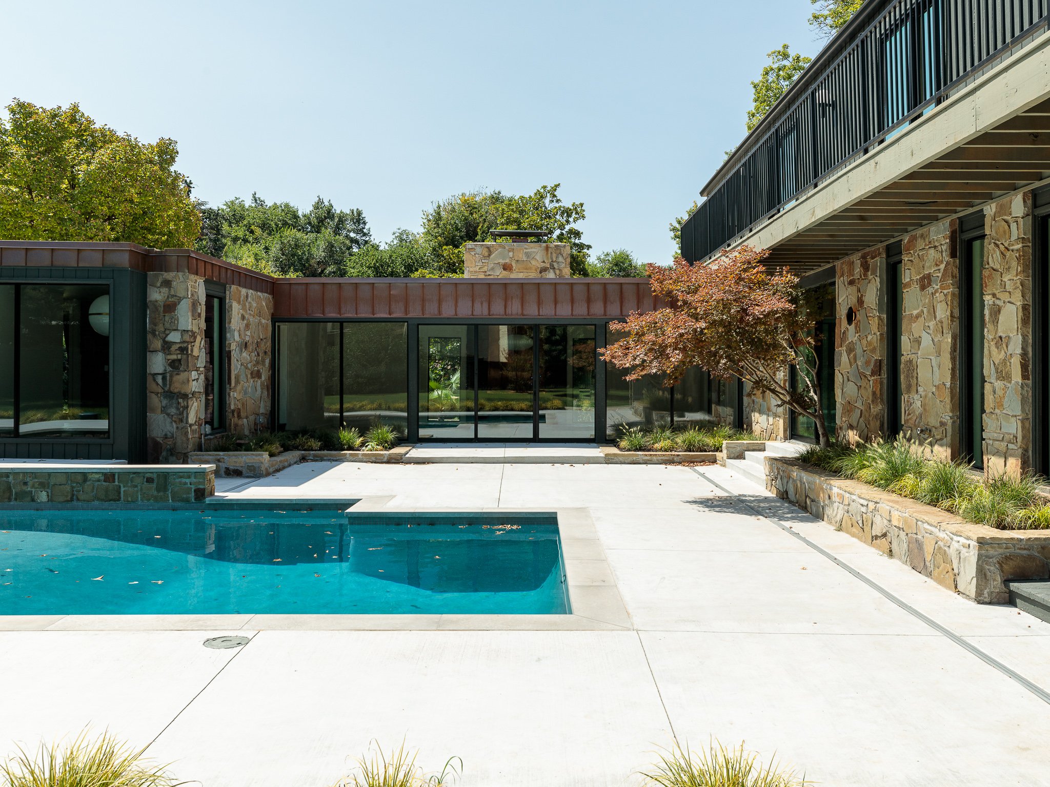 Outdoor living with custom pool, patio and outdoor living area. Renovation by Brent Swift + SwiftCo in Norman, Oklahoma. Purpose is to show our quality of work.