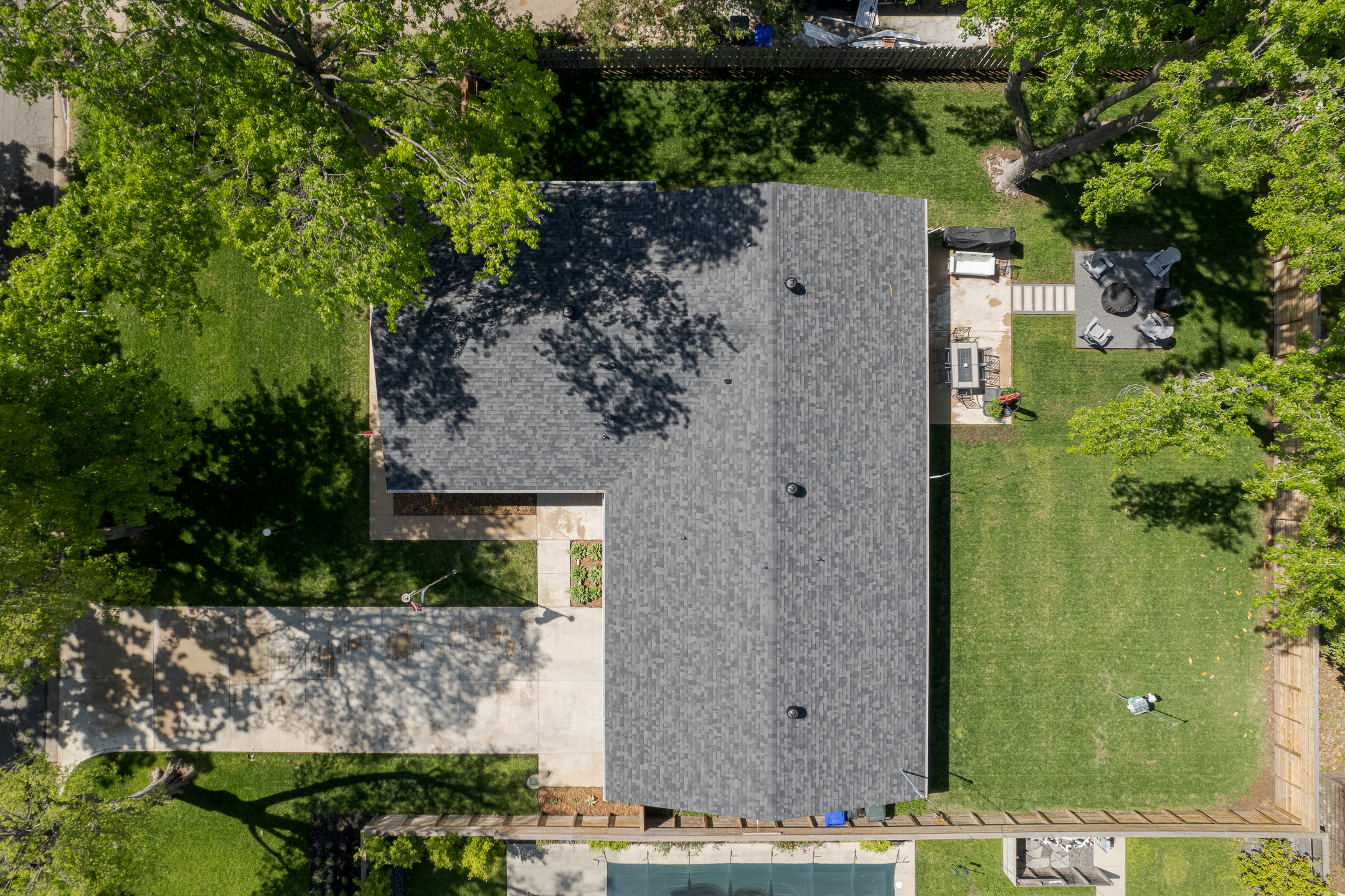 Arial drone view of single gable roof with asphalt shingles. Roofing by Brent Swift + SwiftCo Roofing in Norman Oklahoma. Purpose is to show our quality of work.